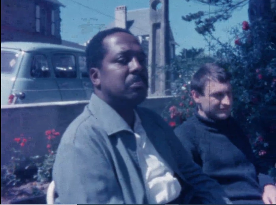 Bud Powell and Paudras sitting at a cafe table