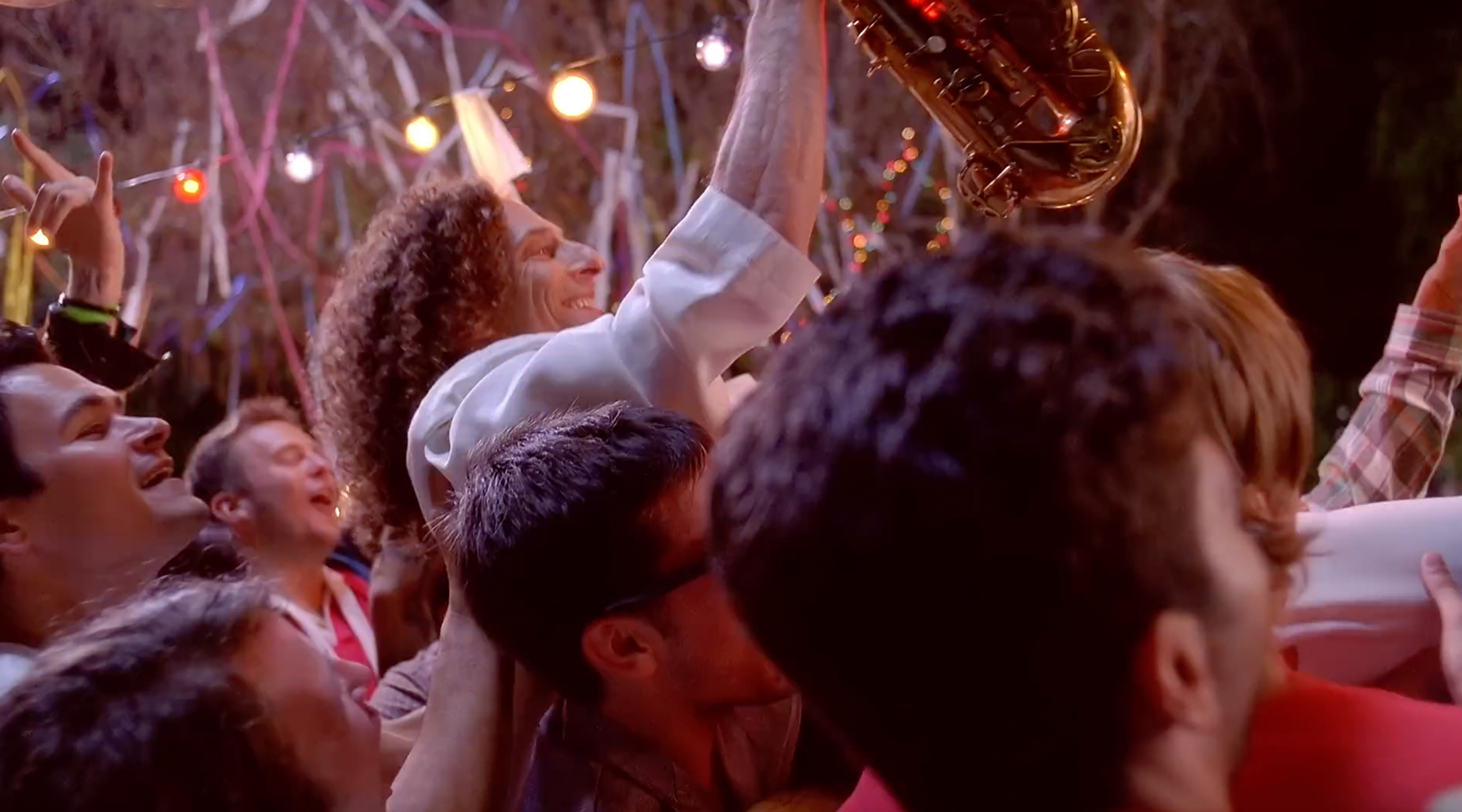 Kenny G being carried away by the partygoers