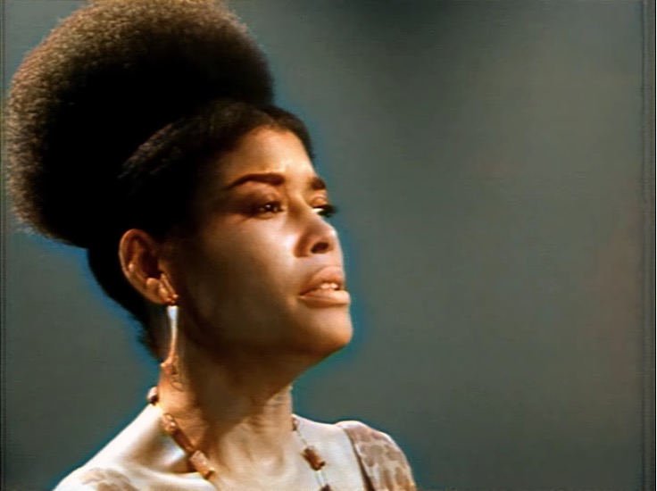 Abbey Lincoln's shoulders and head in frame