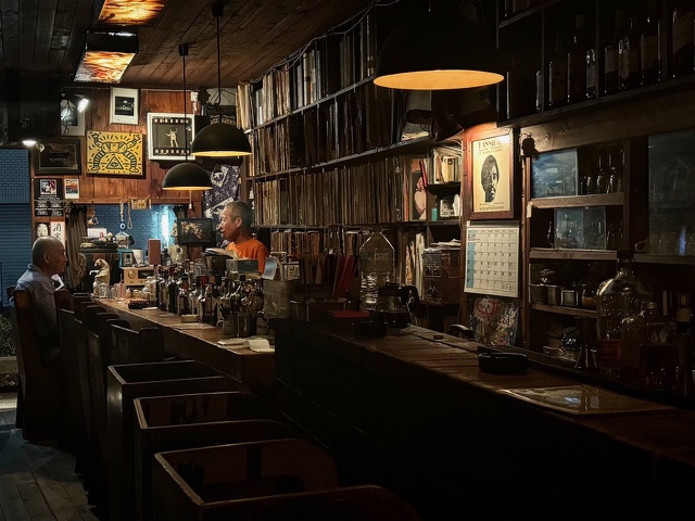 a bartender and patron talking