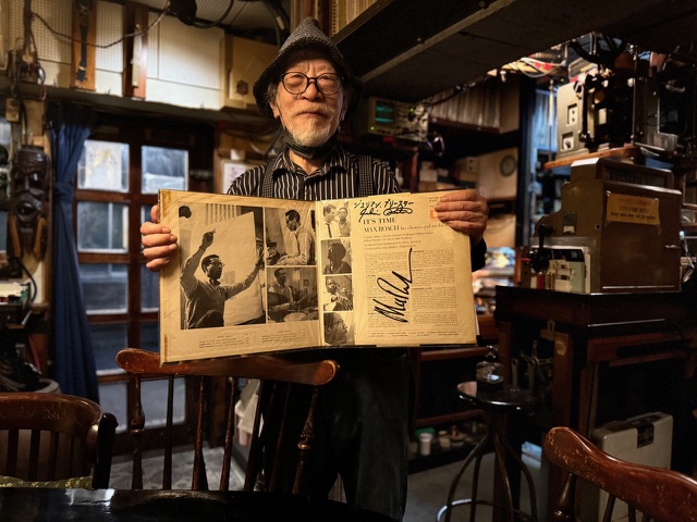 a kissa owner holding an LP